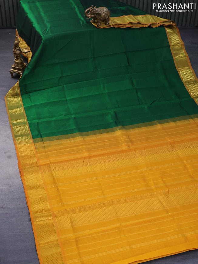 Silk cotton saree green and mustard yellow with plain body and zari woven border