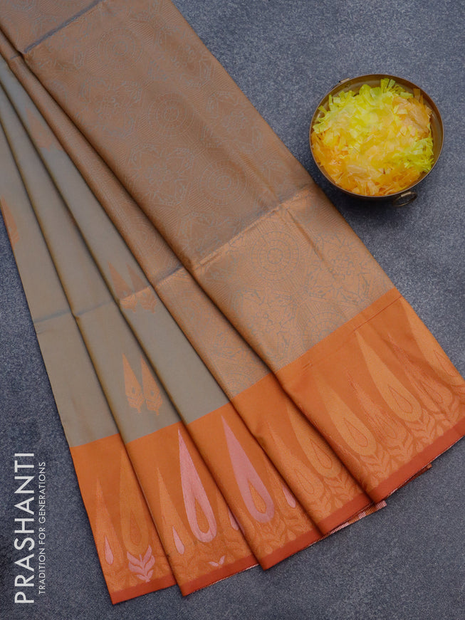 Semi soft silk saree dual shade of bluish beige and rustic orange with copper zari woven buttas and zari woven border