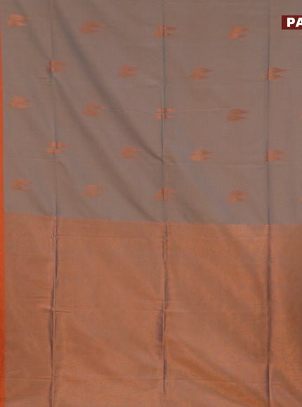 Semi soft silk saree dual shade of bluish beige and rustic orange with copper zari woven buttas and zari woven border