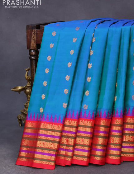 Pure gadwal silk saree dual shade of teal bluish green and red with zari woven buttas and temple design zari border