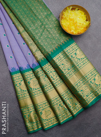 Semi gadwal saree blue and green with allover stripes pattern and temple design long zari woven border