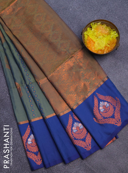 Semi soft silk saree dual shade of bluish green and blue with allover self emboss & zari weaves and copper zari woven butta border