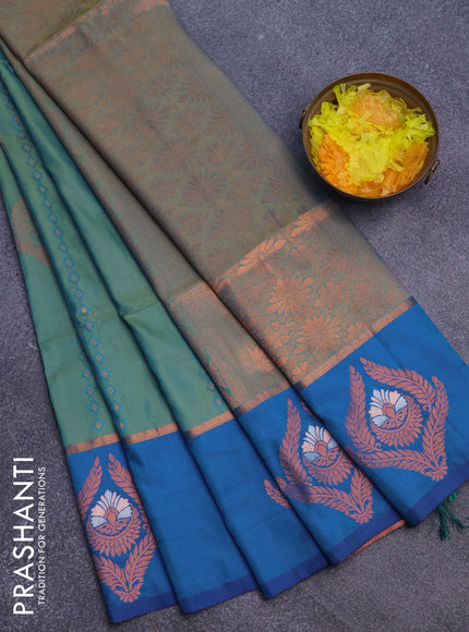 Semi soft silk saree dual shade of teal bluish green and cs blue with allover self emboss & zari weaves and copper zari woven butta border