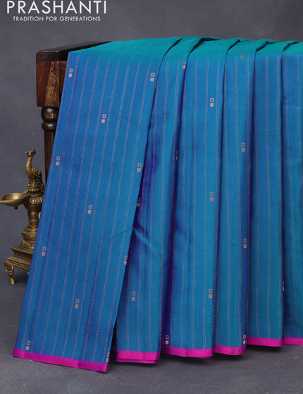 Pure kanchipuram silk saree dual shade of teal bluish green and pink with allover copper zari weaves & buttas and thread woven piping border