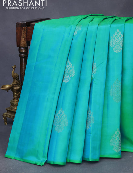 Pure kanchipuram silk saree dual shade of teal bluish green and dark pink with silver zari woven buttas in borderless style