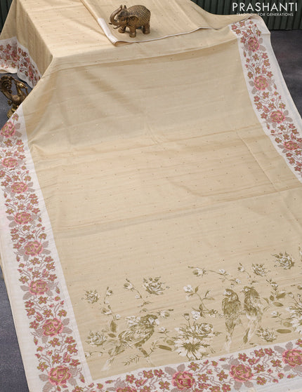 Tussar silk saree beige and cream with allover zari buttas and floral design cross stitched embroidery border