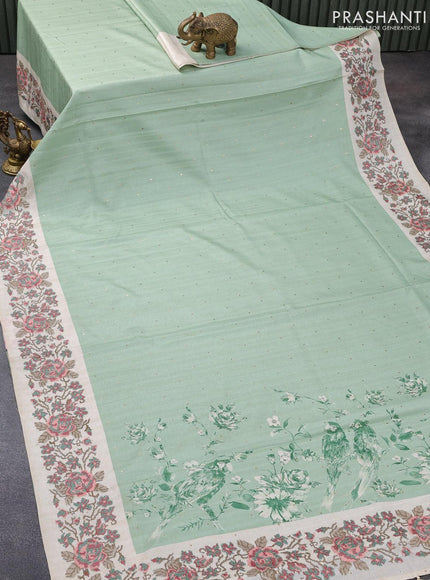 Tussar silk saree pastel green and cream with allover zari buttas and floral design cross stitched embroidery border