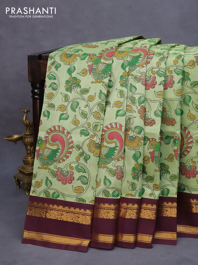 Silk cotton saree pastel green and wine shade with allover kalamkari prints and rettapet zari woven border