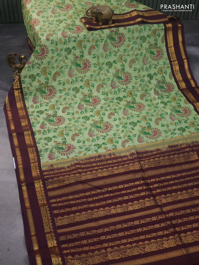 Silk cotton saree pastel green and wine shade with allover kalamkari prints and rettapet zari woven border