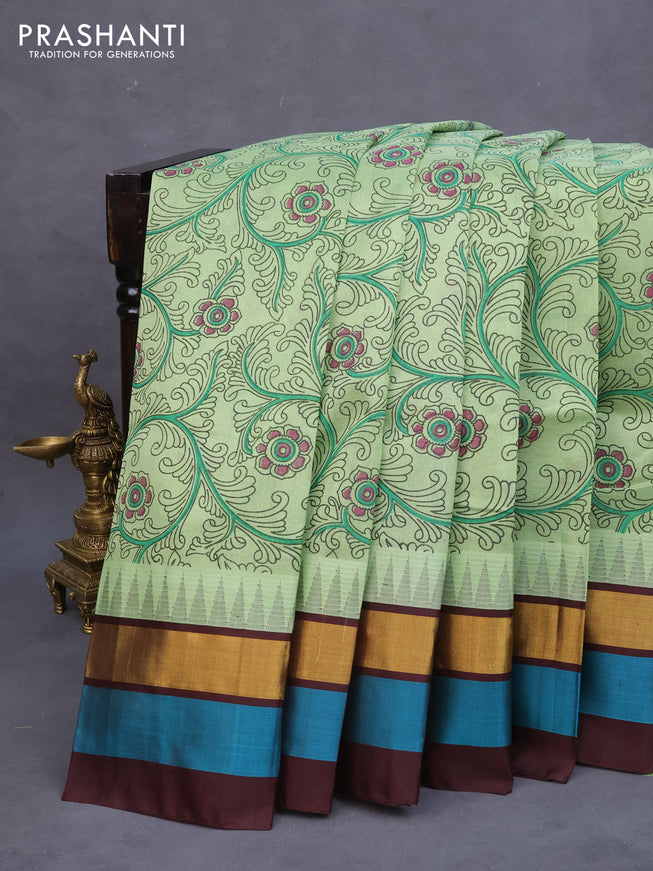 Silk cotton saree pastel green and brown with allover kalamkari prints and temple deisgn zari woven simple border