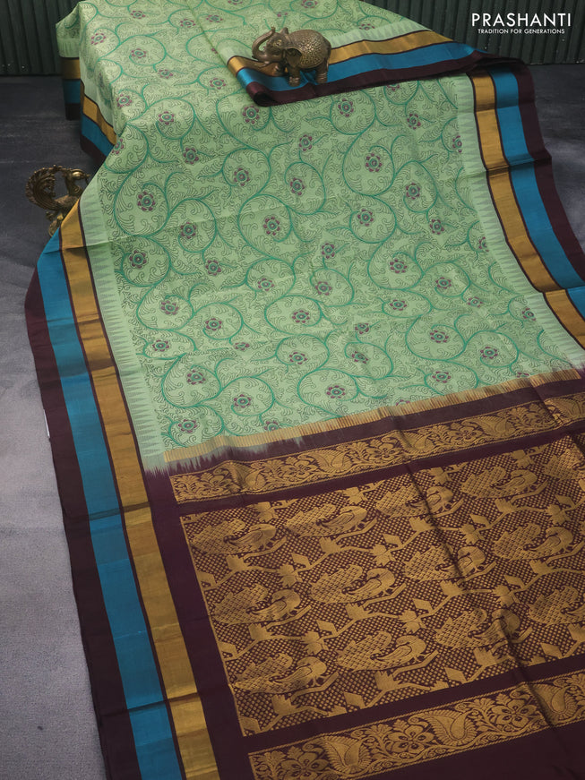 Silk cotton saree pastel green and brown with allover kalamkari prints and temple deisgn zari woven simple border