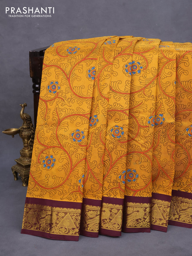 Silk cotton saree mustard yellow and wine shade with allover kalamkari prints and zari woven korvai border