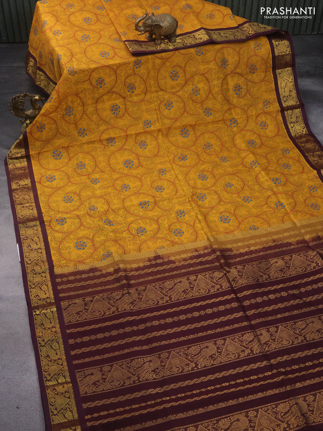 Silk cotton saree mustard yellow and wine shade with allover kalamkari prints and zari woven korvai border