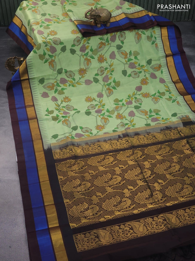 Silk cotton saree pastel green and coffee brown with allover kalamkari prints and temple design zari woven simple border