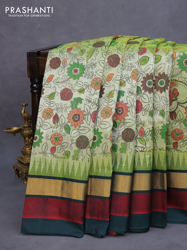 Silk cotton saree pastel green and bottle green with allover kalamkari prints and temple design zari woven simple border