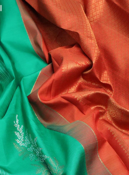 Pure kanjivaram silk saree teal green and rustic orange with allover zari weaves & buttas in borderless style