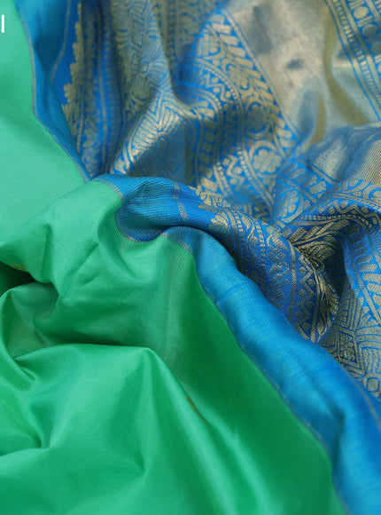 Pure gadwal silk saree green shade and cs blue with allover zari woven buttas and long zari woven border