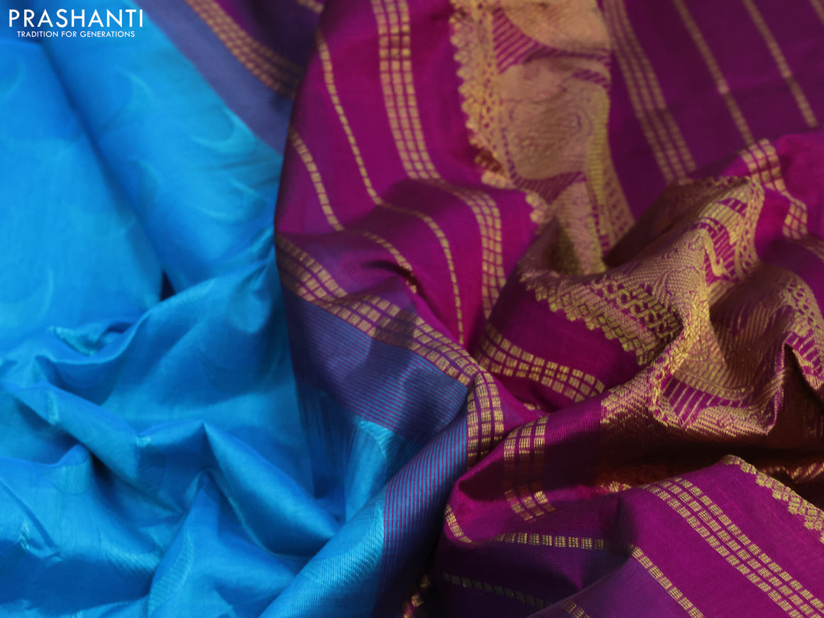 Silk cotton saree light blue and magenta pink with allover self emboss jaquard and elephant design zari woven border