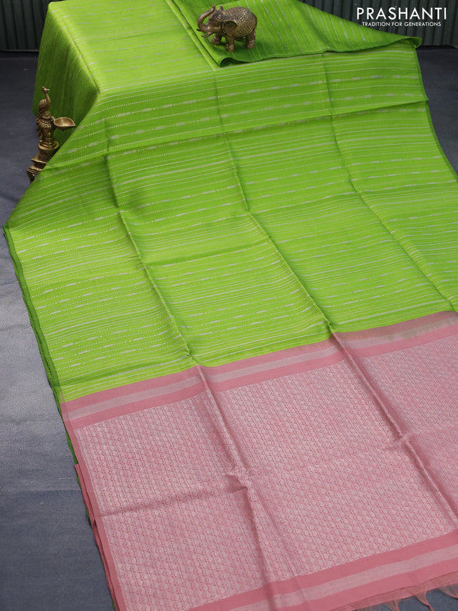 Pure raw silk saree light green and pastel brown with allover silver zari weaves in borderless style