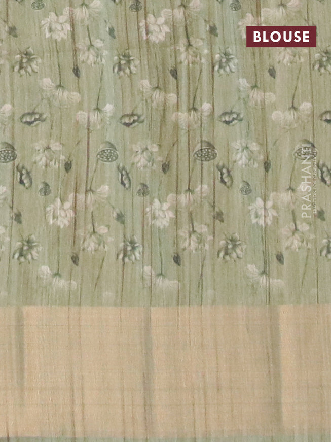 Semi matka saree pastel green shade with allover floral prints and zari woven border