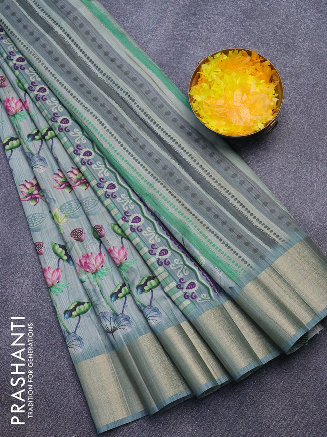 Semi matka saree pastel blue shade with allover floral prints and zari woven border