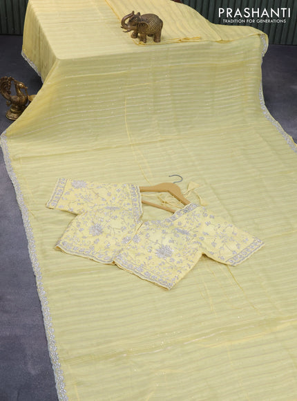 Organza silk saree yellow with allover zari woven stripes pattern and stone work border with sequin work readymade blouse