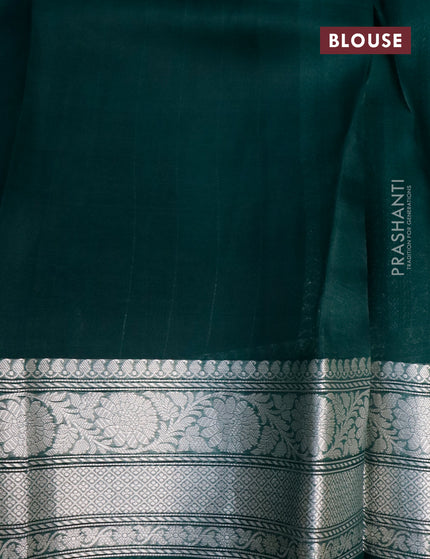 Banarasi organza silk saree dark peacock green with allover silver zari woven buttas and silver zari woven border