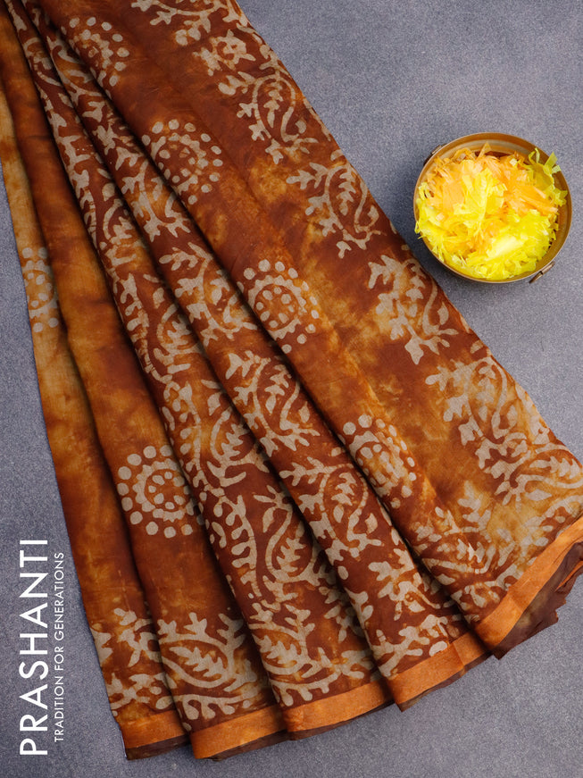 Muslin cotton saree dark mustard and rust shade with batik butta prints and small zari woven border