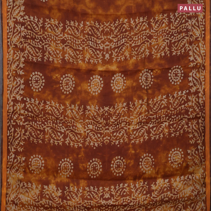 Muslin cotton saree dark mustard and rust shade with batik butta prints and small zari woven border