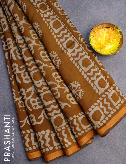 Muslin cotton saree dark mustard with allover batik prints and small zari woven border