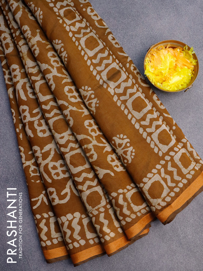 Muslin cotton saree dark mustard with allover batik prints and small zari woven border