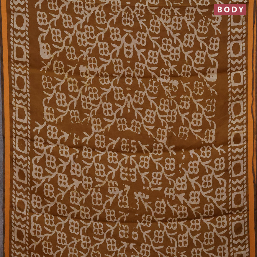 Muslin cotton saree dark mustard with allover batik prints and small zari woven border