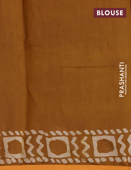 Muslin cotton saree dark mustard with allover batik prints and small zari woven border