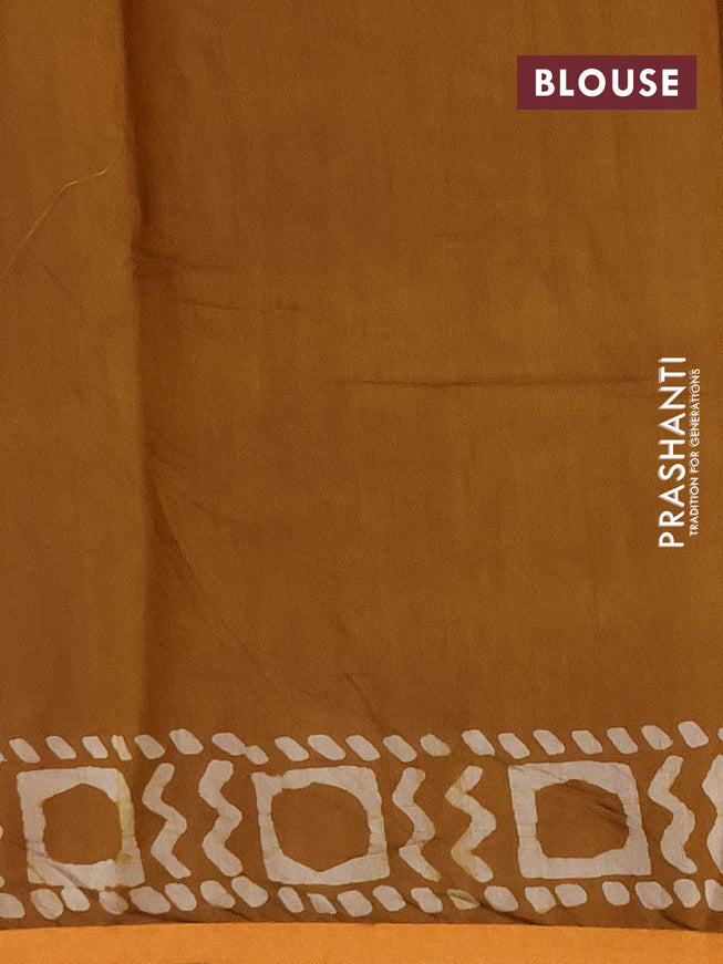 Muslin cotton saree dark mustard with allover batik prints and small zari woven border