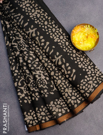 Muslin cotton saree black with allover batik prints and small zari woven border