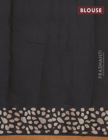 Muslin cotton saree black with allover batik prints and small zari woven border