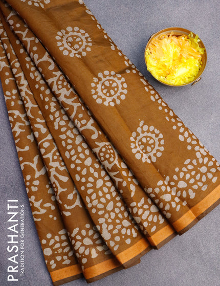 Muslin cotton saree dark mustard with allover batik prints and small zari woven border