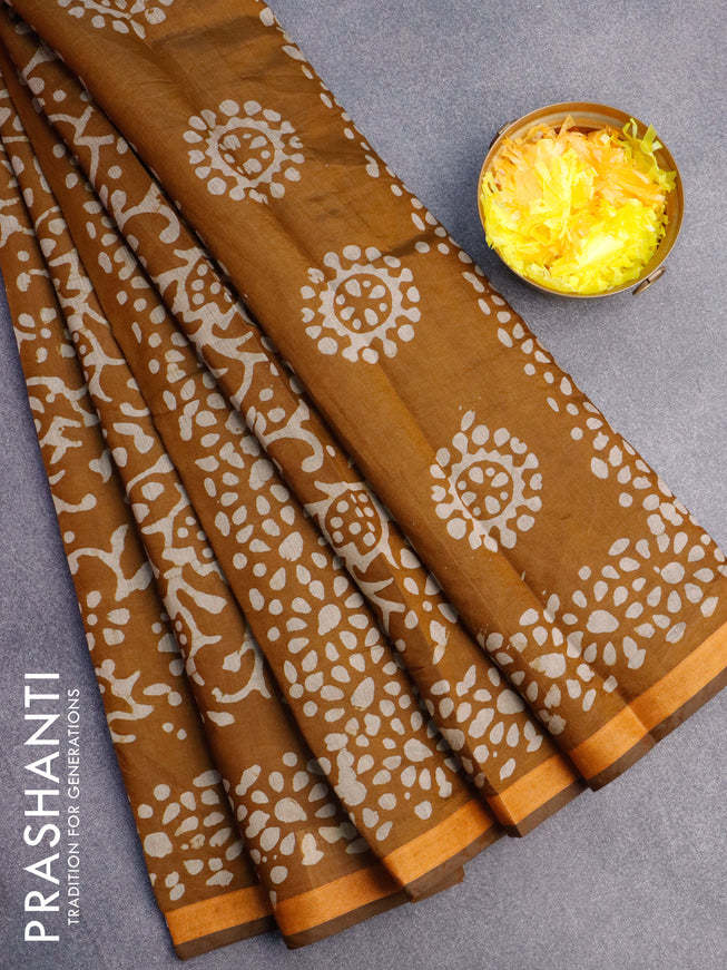 Muslin cotton saree dark mustard with allover batik prints and small zari woven border