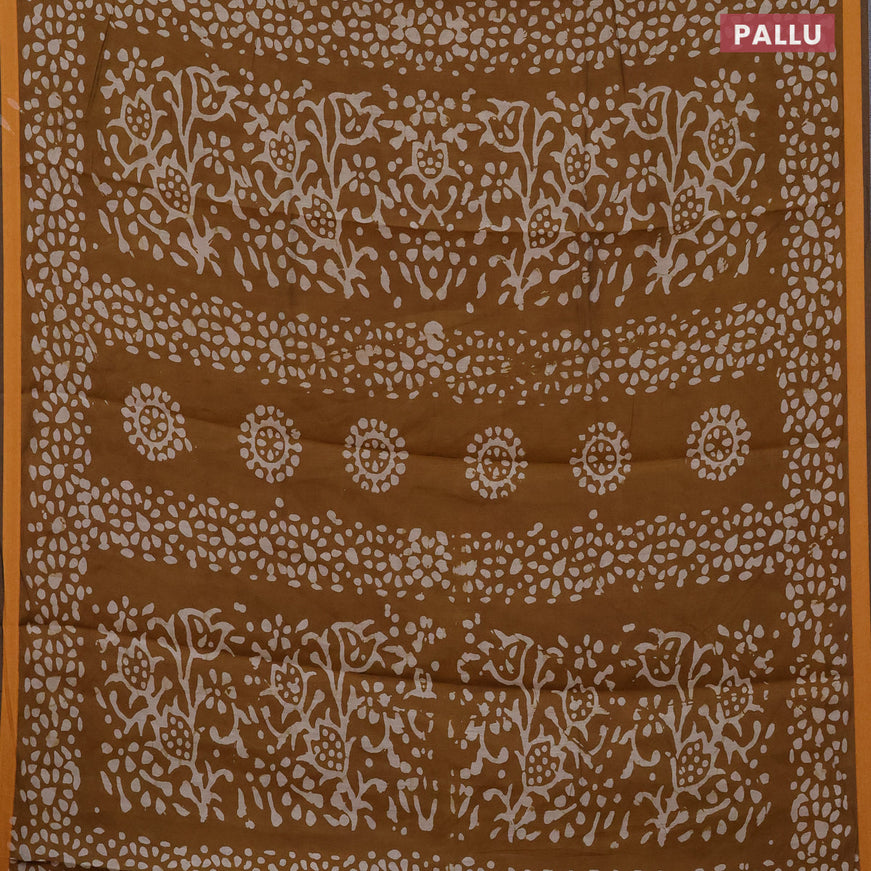 Muslin cotton saree dark mustard with allover batik prints and small zari woven border