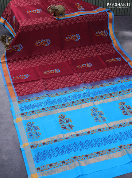 Silk cotton block printed saree maroon and cs blue with allover prints and zari woven border