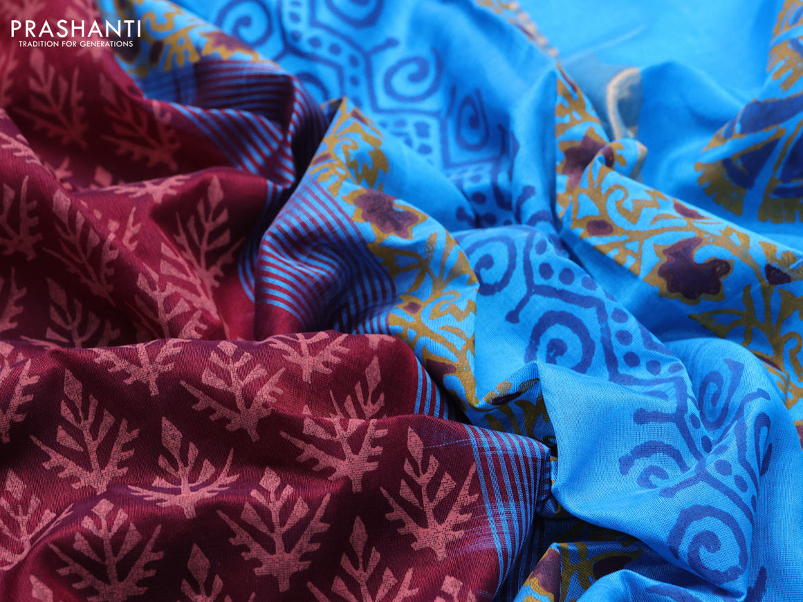 Silk cotton block printed saree maroon and cs blue with allover prints and zari woven border