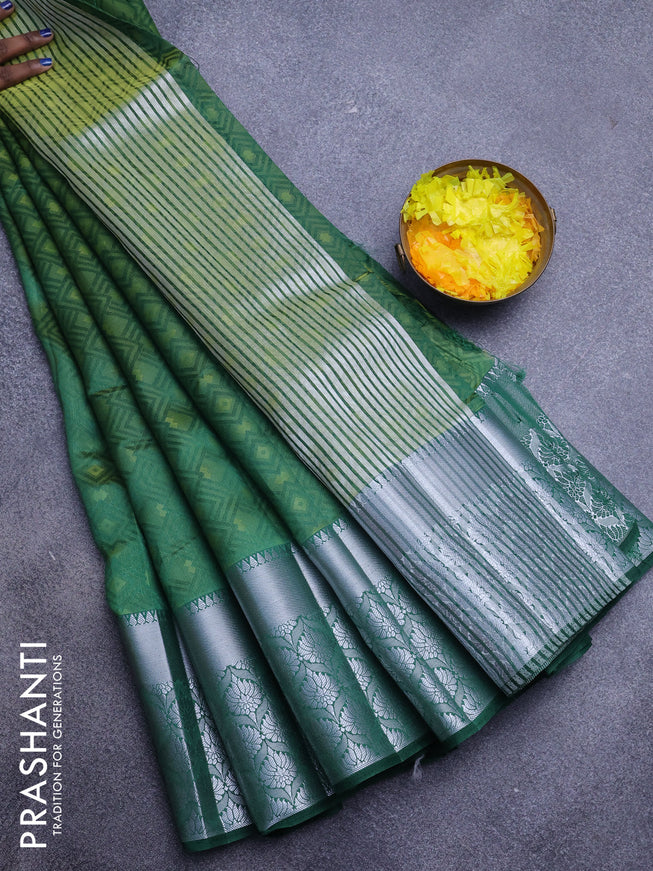 Semi raw silk saree dual shade of dark green with allover self emboss and long silver zari woven border