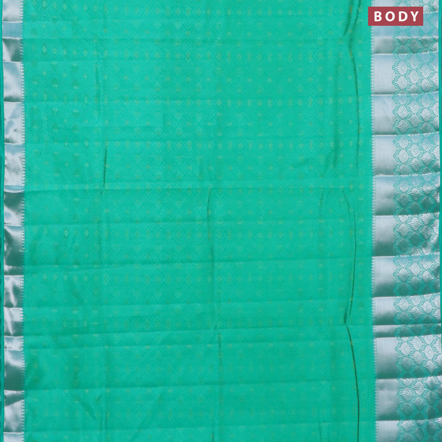 Semi raw silk saree dual shade of teal green with allover self emboss and long silver zari woven border