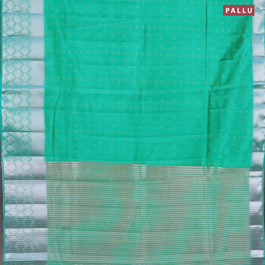 Semi raw silk saree dual shade of teal green with allover self emboss and long silver zari woven border