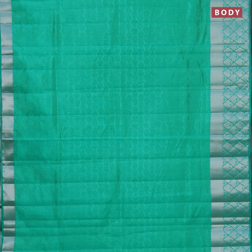 Semi raw silk saree dual shade of teal green with allover self emboss and long silver zari woven border