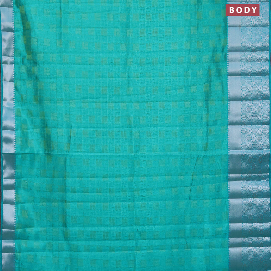 Semi raw silk saree dual shade of teal blue with allover self emboss and long silver zari woven border