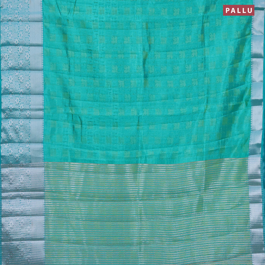 Semi raw silk saree dual shade of teal blue with allover self emboss and long silver zari woven border