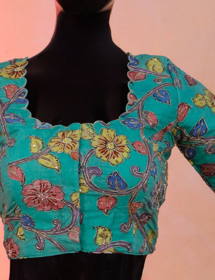 Pen kalamkari readymade blouse teal green with allover kalamkari prints & embroidery work and back knot