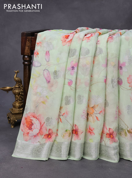 Chiffon silk saree pastel green shade with allover floral digital prints & silver zari buttas and silver zari woven border