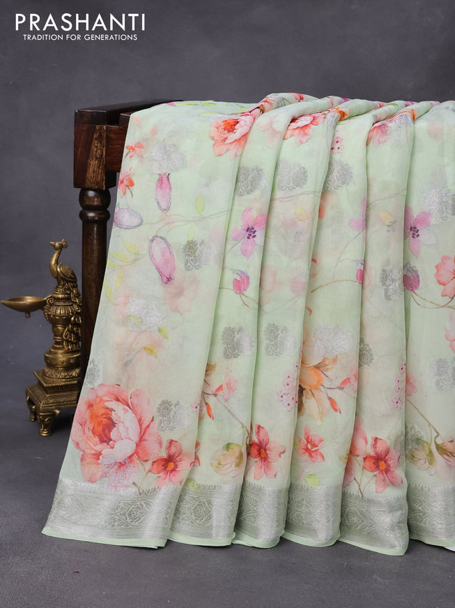 Chiffon silk saree pastel green shade with allover floral digital prints & silver zari buttas and silver zari woven border